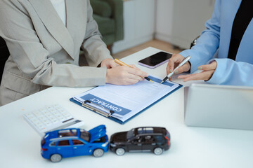 Female signing car insurance document or lease. Writing signature on contract or agreement. Buying or selling new or guarantee.