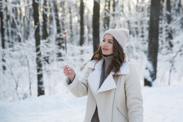 girl with sparkles Bengal fire in winter outdoor. Happy New Year concept. Christmas holiday