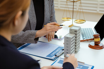 Buying a home or insurance deal, an insurance agent pointing a pen to those interested in renting a house, a contract.