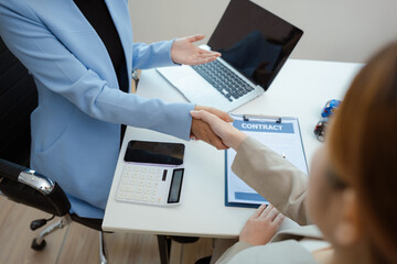 Close up shake hands, Car Dealership and sign contracts in car showrooms or car dealership offices, successful deal.