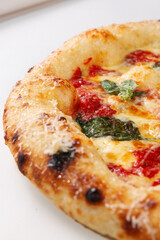 Close up margherita pizza showing baked crust melted cheese tomato sauce and basil leaves