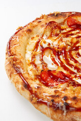 Close up of baked meat pizza with bacon sausages fried onion melted cheese and rich sauce