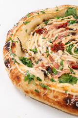 Close up pizza showing baked crust ham mushrooms cheese sauce and fresh herbs