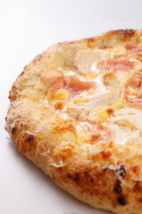 Close up of white pizza with ham and melted cheese on white background