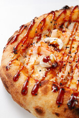 Close up pizza with shrimp cream cheese teriyaki sauce sesame and baked crust