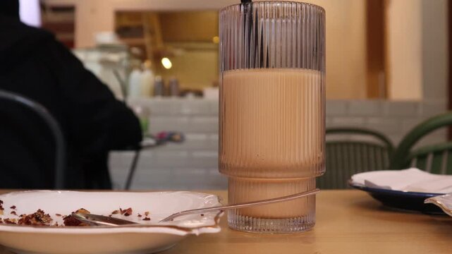 drinks on a table with a cafe in the background.