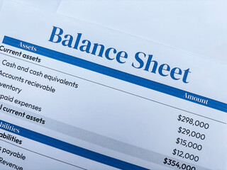 Balance sheet of a business concept showing on the paper top view backdrop.