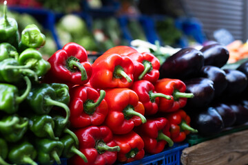 Pile of bell peppers displayed on market counter