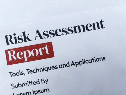 Risk Assessment report title close up background frop top.