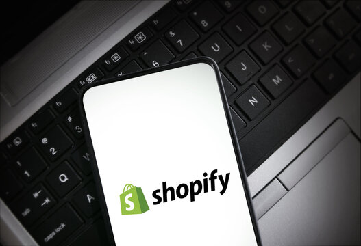Shopify E-commerce store management from the smartphone concept editorial background.