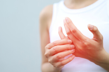 young woman hand pain her wrist. injury, feeling pain from cramp, trigger finger, touching massaging, ache joint. Health care and medical concept.	
