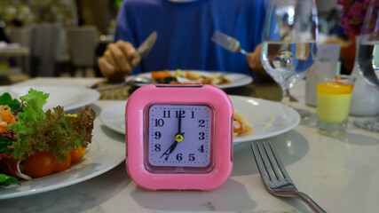 Pink Alarm Clock Waiting for the IF Meal Intermittent Fasting Concept