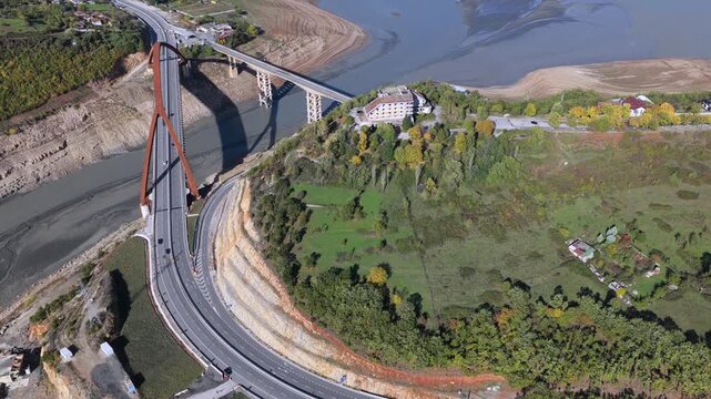 Aerial video of Kuk&euml;s showing the A1 bridges, lake shoreline, and surrounding hills in warm autumn tones.