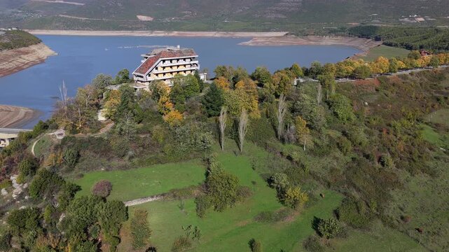 Aerial video of the Kuk&euml;s hillside greenery and Lake Fierza, with autumn colours and mountain scenery in northern Albania.