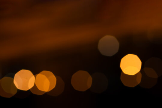 Abstract beautiful gold yellow soft octagon bokeh from ornamental lights flickering in the park with  copy space. Background for celebrate party, merry Xmas, happy new year concept.