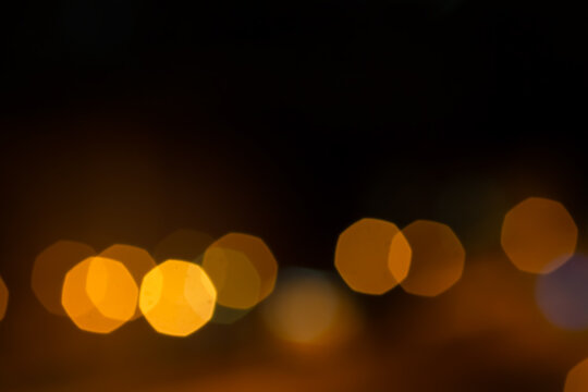Abstract beautiful gold yellow soft octagon bokeh from ornamental lights flickering in the park with  copy space. Background for celebrate party, merry Xmas, happy new year concept.