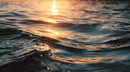 Golden hour sunlight shimmering on gentle ocean waves, creating a serene and tranquil natural scene