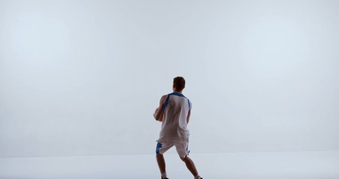 Basketball player leaping upward with arms fully extended holding ball overhead. Concept of vertical jump analysis, movement diagrams, sports infographics, and athletic performance assessment.