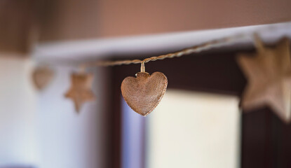 Wooden heart garland hanging as cozy home decoration