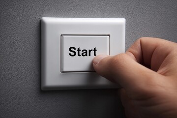 Hand pressing start button on a wall switch