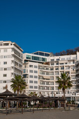 Luxury apartments on the coast with palm trees and sea views.
