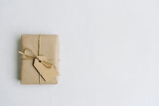 Eco-Friendly Gift Wrapping: Brown Paper Package with Twine and Tag