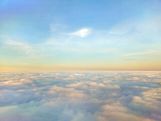 Cloudscape from above and colorful sky on an early morning 