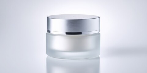 Obraz premium Luxury cream jar with brushed silver lid on white background