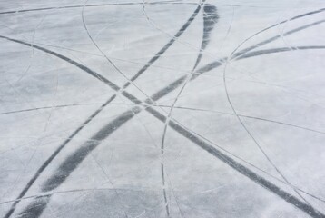 Skate marks on icy surface in winter light