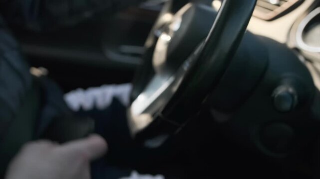 man checks phone, driver looks at smartphone while adjusting seat, man checking his phone while seated in vehicle and adjusting gear, man is looking at his phone inside car as he adjusts his seat