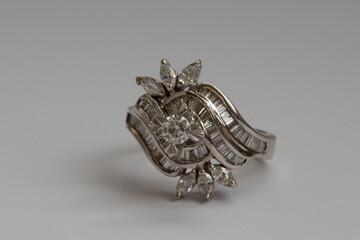 A stunning large white gold ring with natural round, marquise, and trapezoid diamonds.