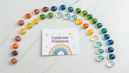 Arrangement of Rainbow Marbles Glowing Above a Milestone Card