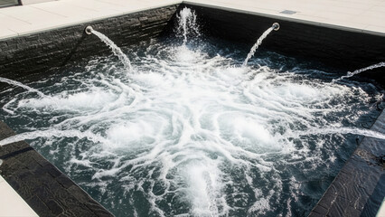 Luxurious spa plunge tub with dynamic water ripples and cascading jets creating a calming ambiance, surrounded by sleek modern tiles
