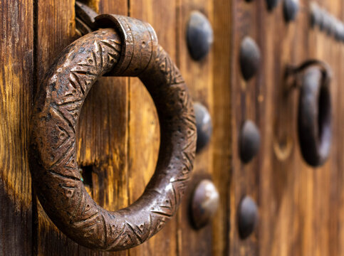 Close-up of a traditional metal door handle on an old wooden door in Morocco. - Powered by Adobe