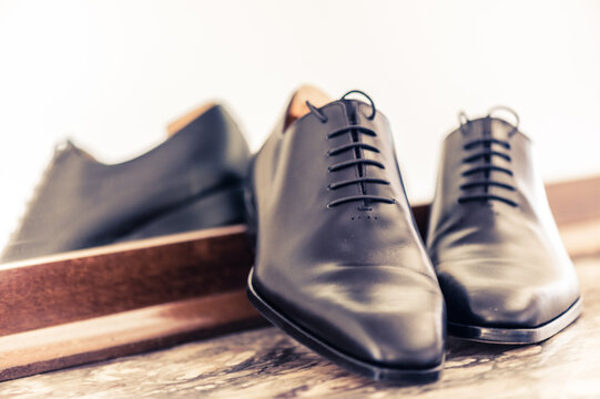 Close-up of a pair of shoes leaning against a mirror