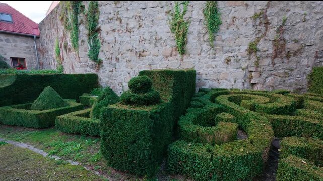 FREISTADT, AUSTRIA &ndash; SEPT 26, 2025. Aerial and ground video of a formal boxwood hedge maze in a historic park in Freistadt, Upper Austria on a sunny day. Footage showing green maze pathways and garden