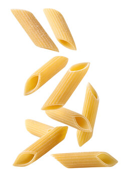 Raw penne pasta pieces falling isolated on transparent background