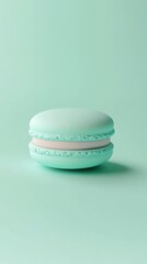 Cool mint green background with a 3D small macaron in the middle, pastel-colored and delicate 