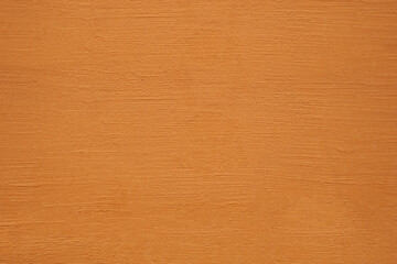 Textured background. Decorative plaster stucco concrete walls, external decoration of facade. Texture of yellow brown beige. Baked clay similar to cement or terracotta background. coating Rustic wall