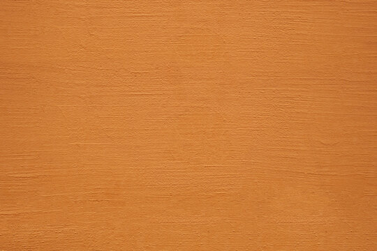 Textured background. Decorative plaster stucco concrete walls, external decoration of facade. Texture of yellow brown beige. Baked clay similar to cement or terracotta background. coating Rustic wall