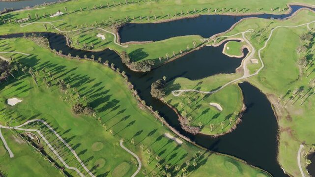 The Ultimate Retirement Dream: Cinematic Aerial Flyover of Salgados Golf Course Nestled Between the Atlantic Ocean and Natural Lagoons in Algarve, Portugal