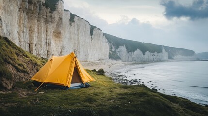 A vibrant yellow tent stands against a dramatic cliffside by the ocean. The serene landscape invites exploration and relaxation. Experience nature like never before. Generative AI