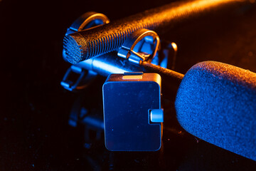 Close up on a professional boom microphone system on black background. © CesareFerrari