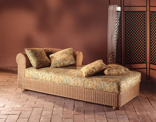 Single shot photo of a room with a wicker sofa