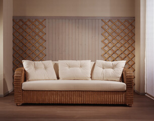 Single shot photo of a room with a wicker sofa