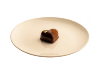 Chocolate heart shaped dessert on a white plate on black