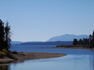 Scenic View of Yellowstone Lake Outlet and Distant Mountains