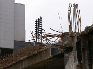 Demolition work on a construction site with concrete pillars, steel beams, etc.