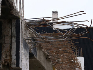 Demolition work on a construction site with concrete pillars, steel beams, etc.
