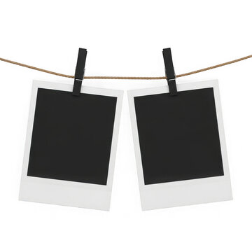 Two polaroid photos hanging on clothespins, isolated on white background